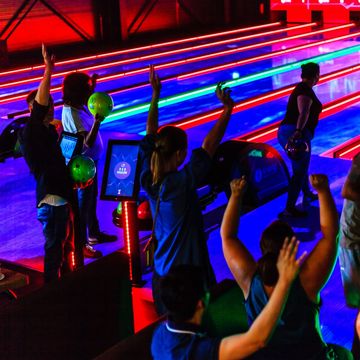 Bowling Bahnen modern mit jubelnden Menschen, die Bowling spielen im Vordergrund, best bowling manufacturer